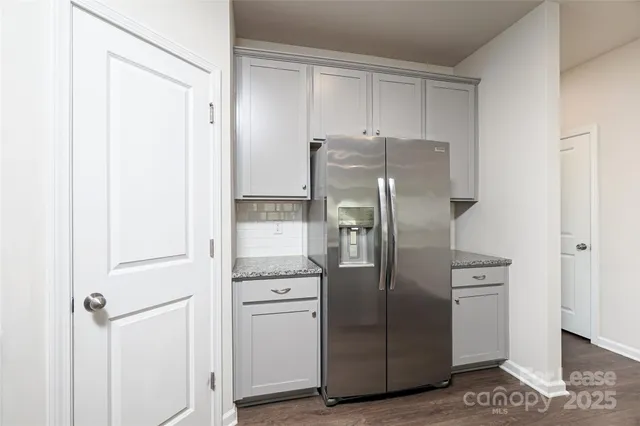 a kitchen with stainless steel appliances a refrigerator and cabinets