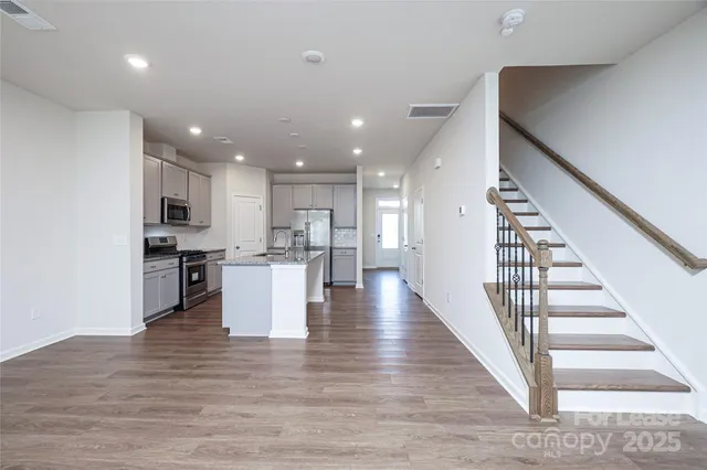 a view of kitchen with wooden floor and electronic appliances