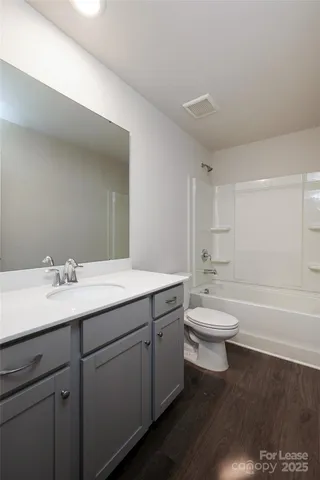 a bathroom with a toilet a sink and bathtub