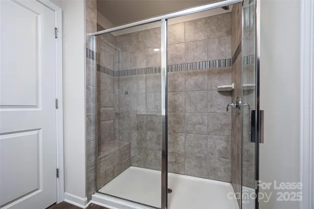 a bathroom with a glass shower door