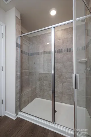 a bathroom with a glass shower door