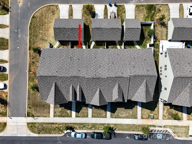 an aerial view of a house with swimming pool and ocean view