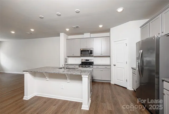 a kitchen with a refrigerator and a sink