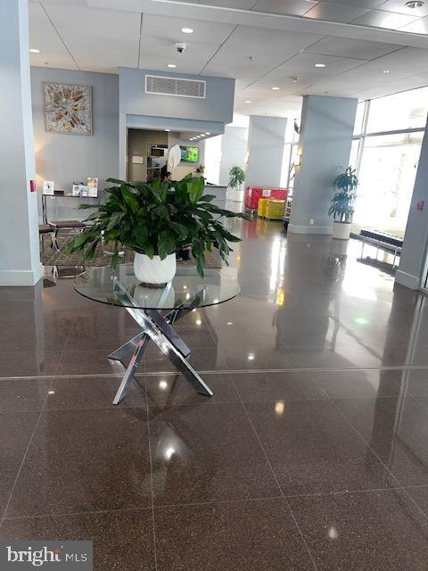 800 4th Street Southwest, Unit S503 Washington, DC 20024 - Photo 15 of 21 a living room with furniture and potted plants
