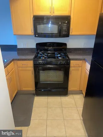 a stove top oven sitting inside of a kitchen