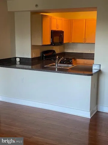 a room with wooden floor and a sink