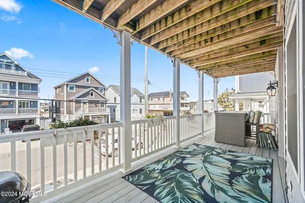 a view of a porch with wooden floor and fence
