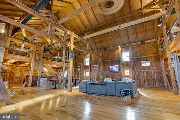 a view of living room with furniture and wooden floor