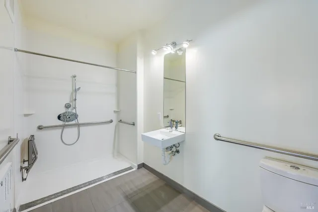 a bathroom with a shower and a sink