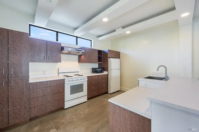a kitchen that has a sink and a stove in it