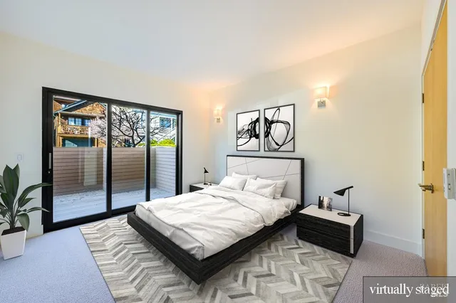 a bedroom with a bed and glass door