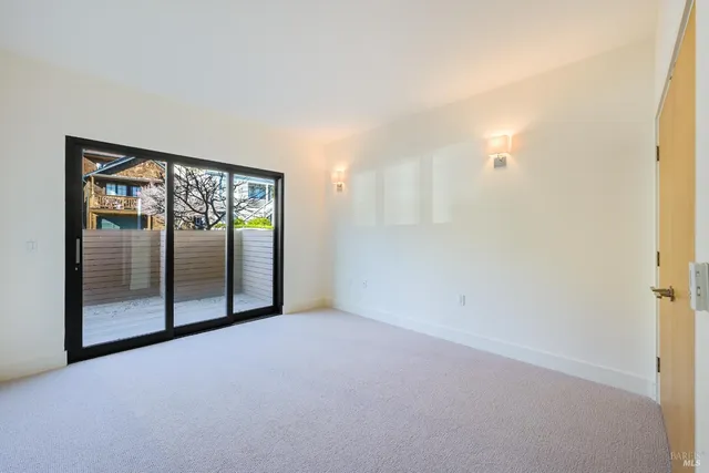 an empty room with sliding glass door