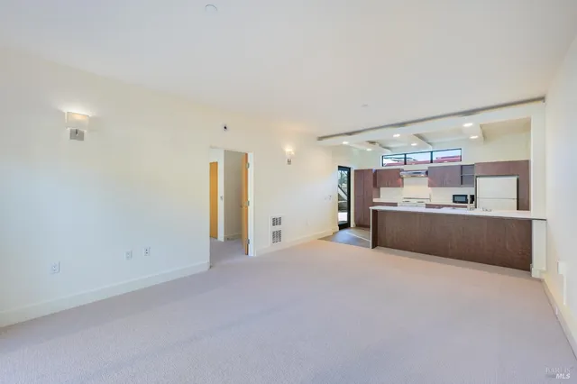 a view of kitchen with refrigerator sink and white cabinets