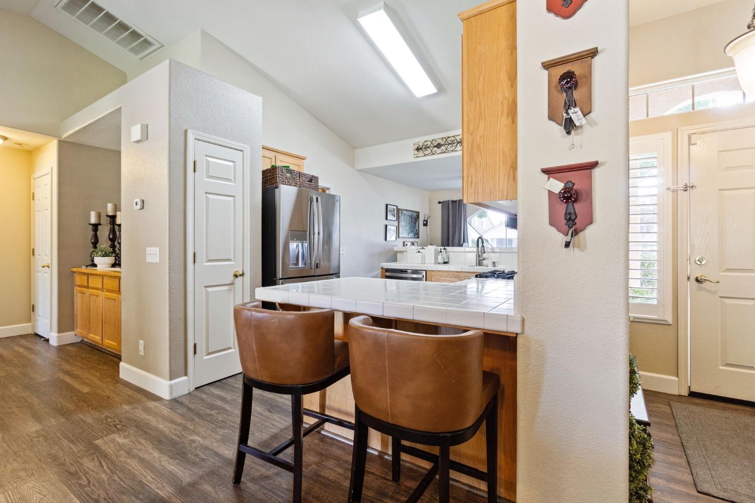 595 Quady Lane Madera, CA 93637 - Photo 11 of 25 a kitchen with stainless steel appliances granite countertop a refrigerator and a dining table