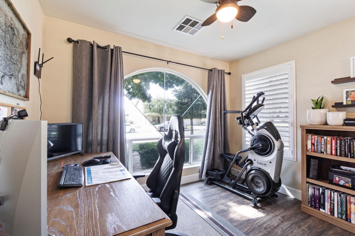 595 Quady Lane Madera, CA 93637 - Photo 14 of 25 a view of a workspace with furniture and a window