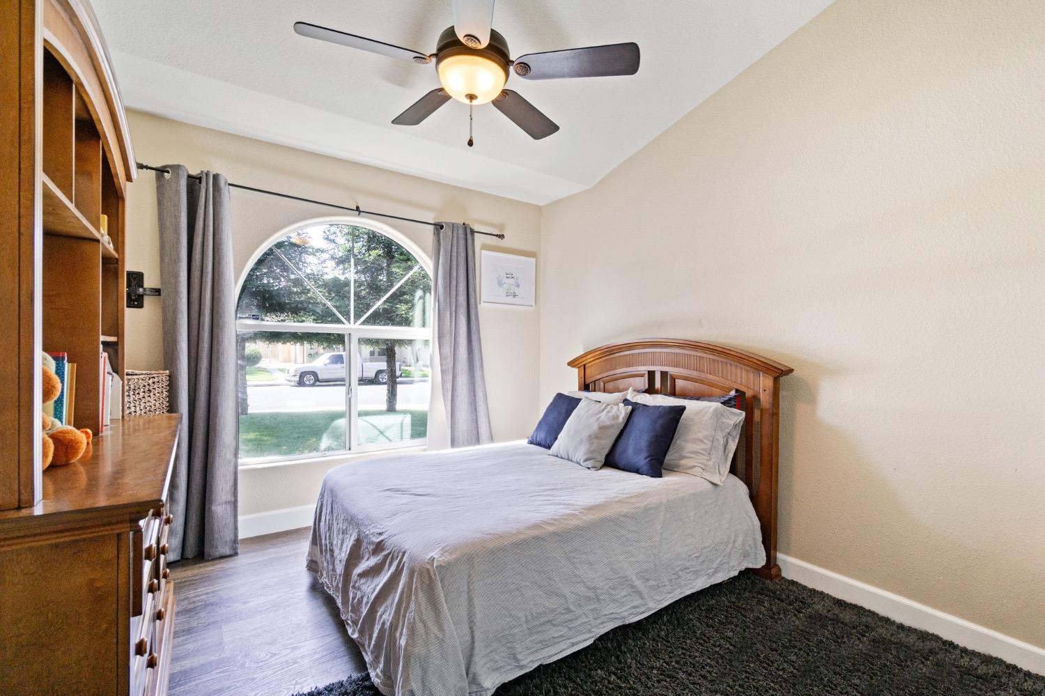 595 Quady Lane Madera, CA 93637 - Photo 16 of 25 a bedroom with a bed and a large window