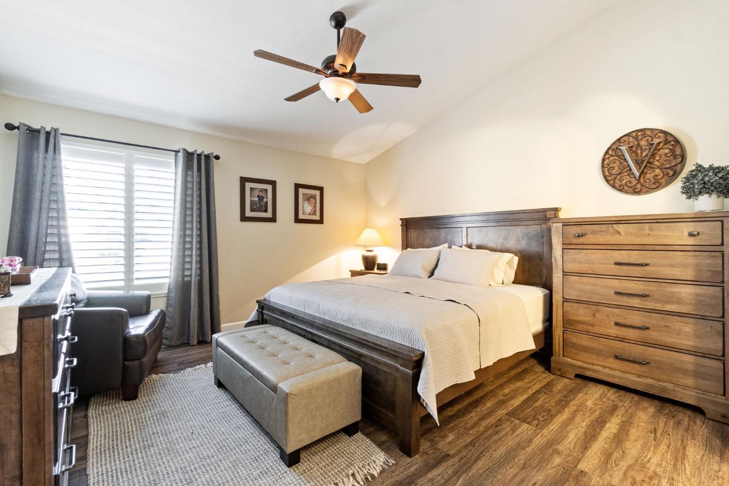 595 Quady Lane Madera, CA 93637 - Photo 19 of 25 a bedroom with a bed a couch and a window