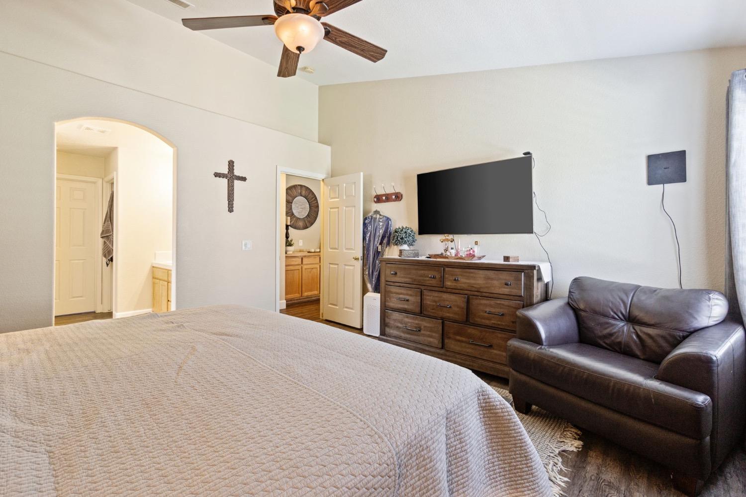 595 Quady Lane Madera, CA 93637 - Photo 20 of 25 a bedroom with a bed and a flat screen tv