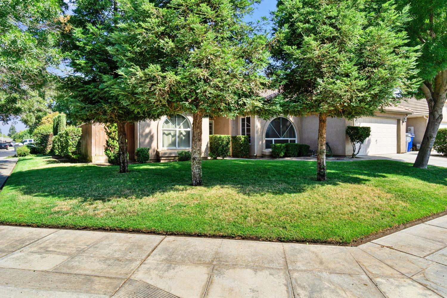 595 Quady Lane Madera, CA 93637 - Photo 2 of 25 a front view of house with yard and green space