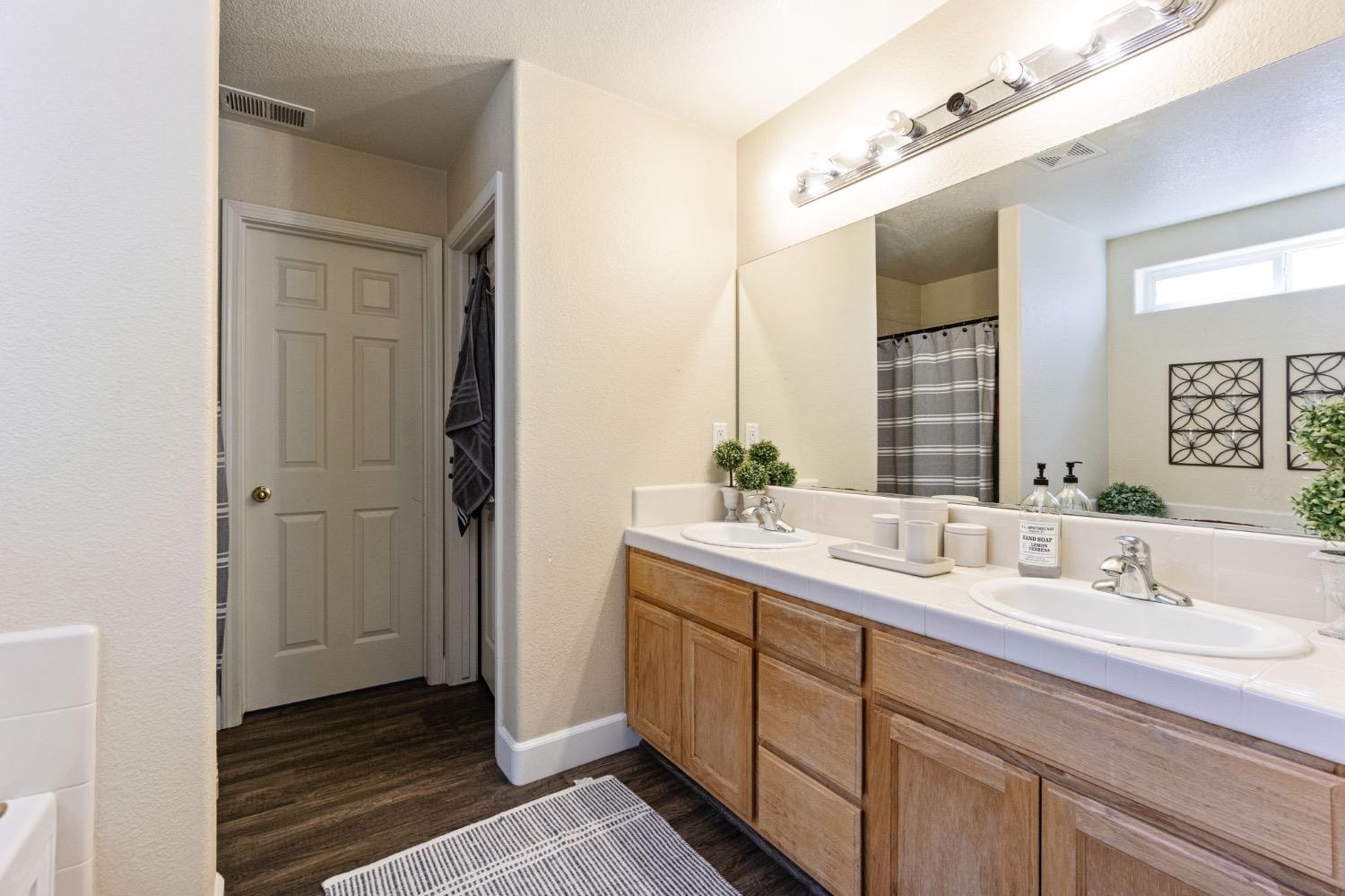 595 Quady Lane Madera, CA 93637 - Photo 21 of 25 a bathroom with a double vanity sink and mirror