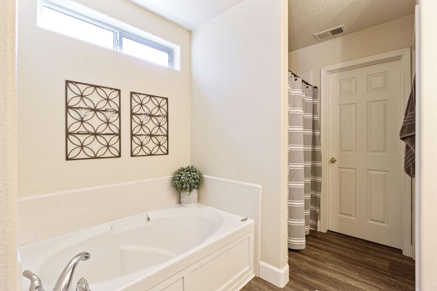595 Quady Lane Madera, CA 93637 - Photo 22 of 25 a white bath tub sitting next to a white sink