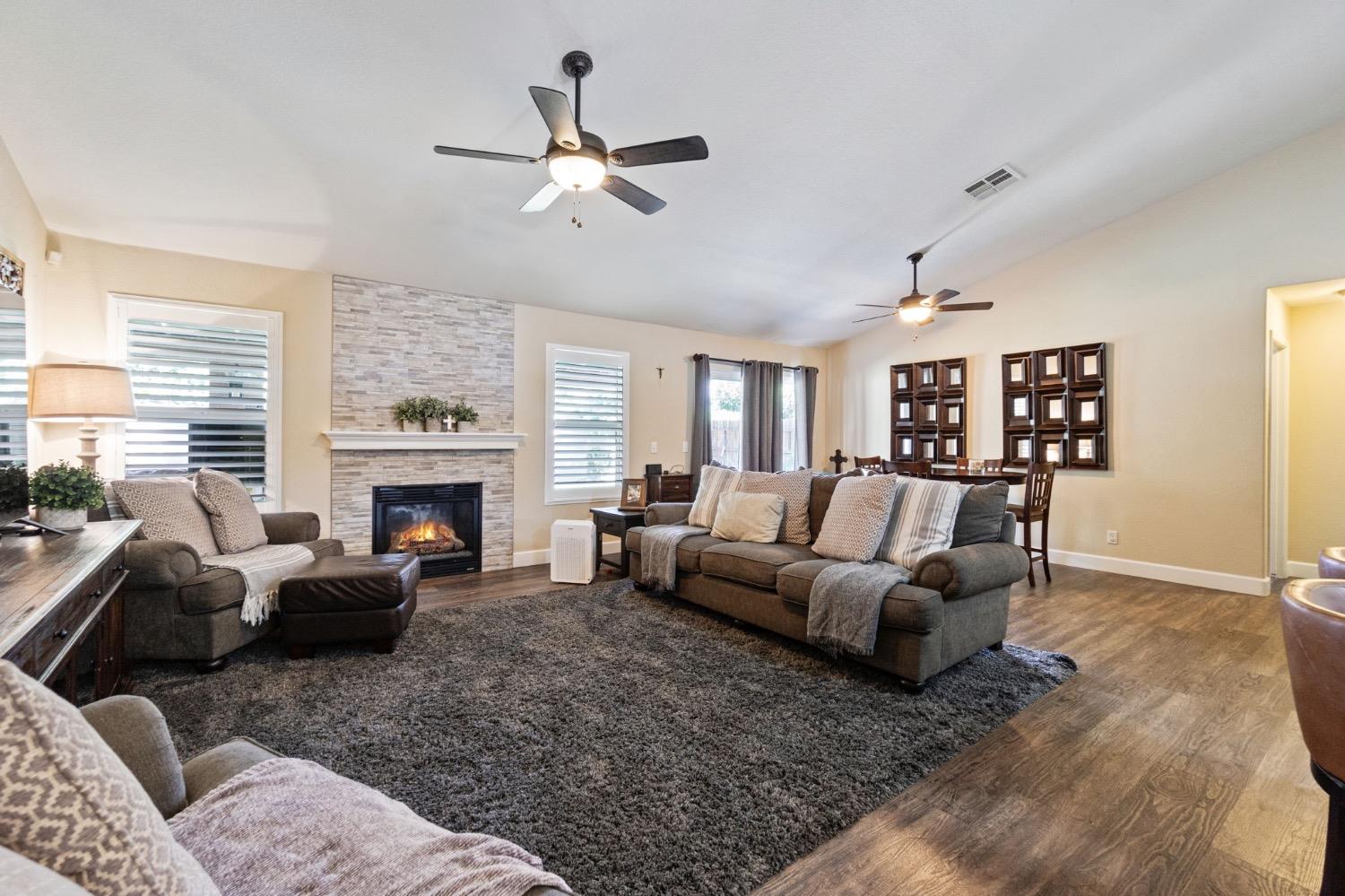595 Quady Lane Madera, CA 93637 - Photo 6 of 25 a living room with furniture and a fireplace