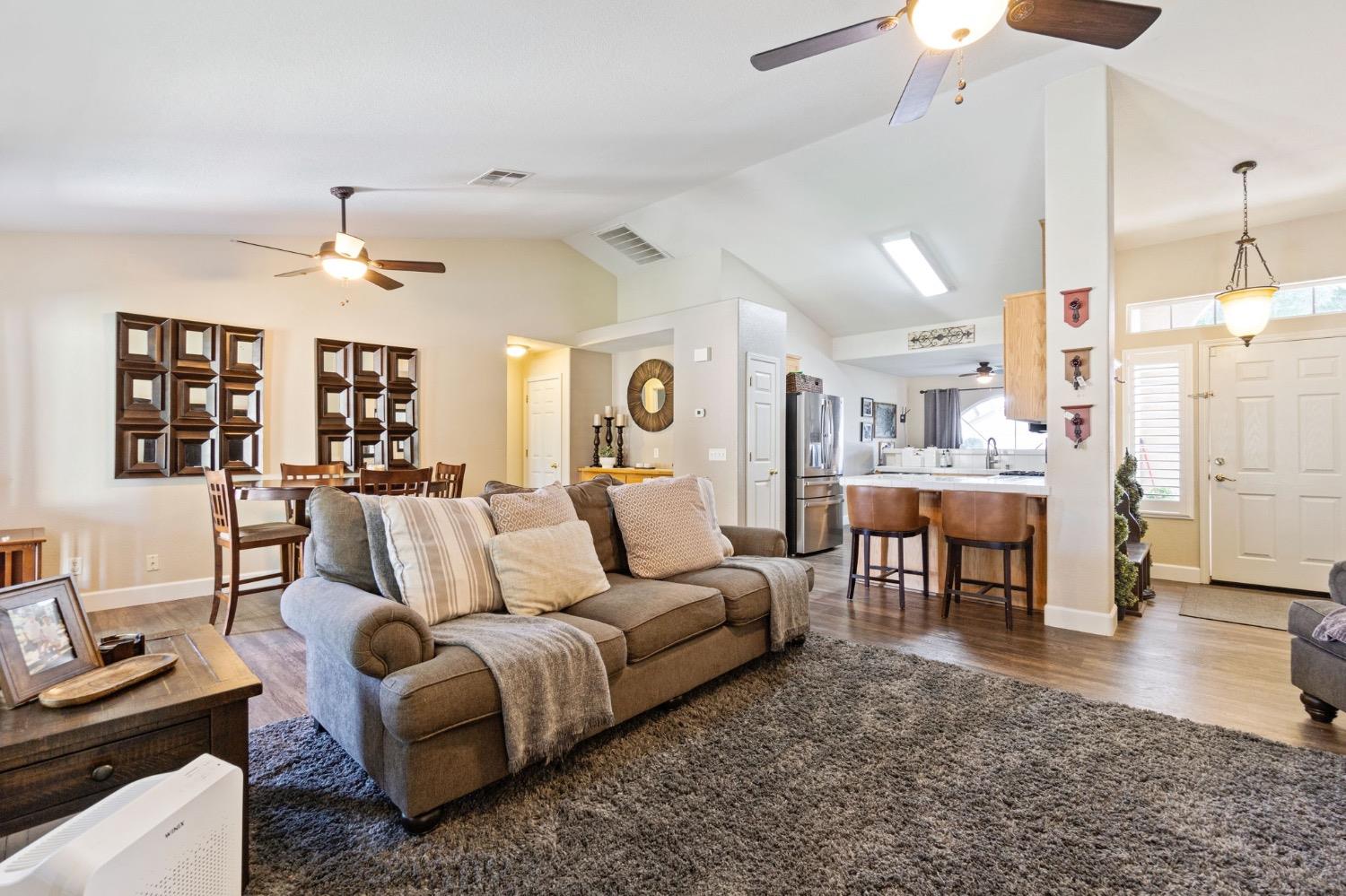 595 Quady Lane Madera, CA 93637 - Photo 7 of 25 a living room with furniture kitchen view and a chandelier