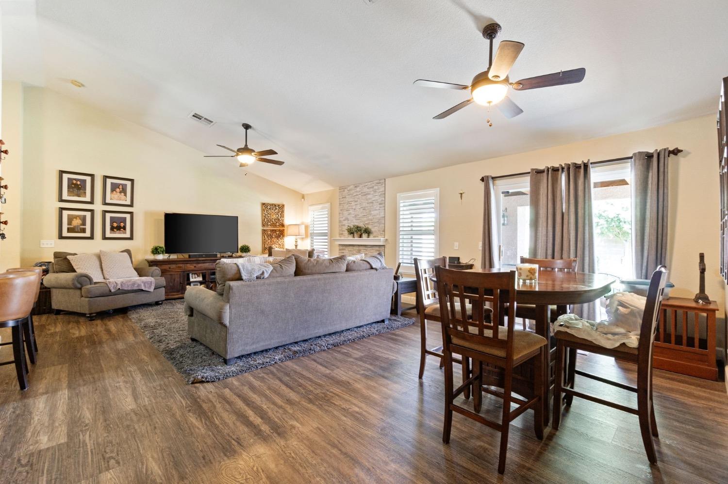 595 Quady Lane Madera, CA 93637 - Photo 9 of 25 a living room with furniture dining table and a flat screen tv