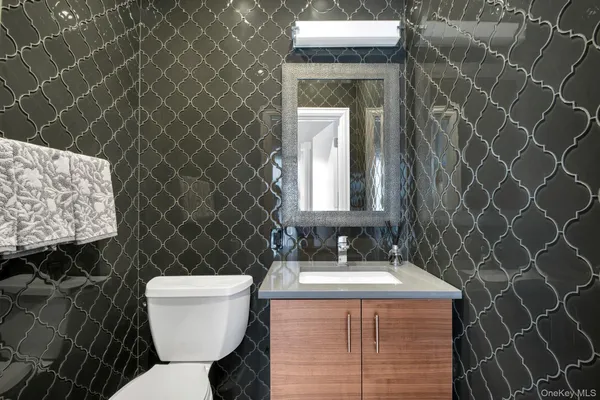 a bathroom with a toilet sink and mirror