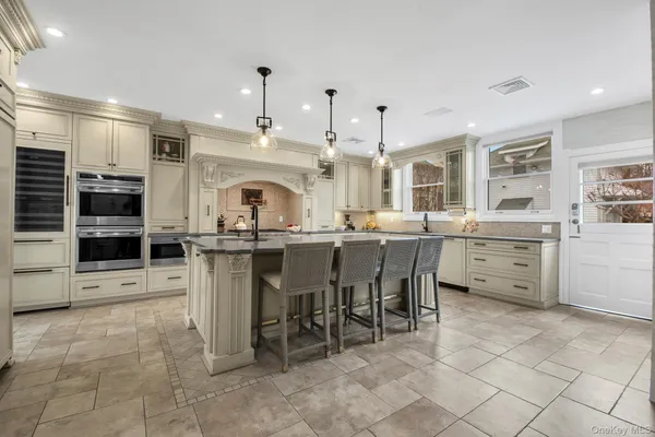 a large kitchen with a table and chairs