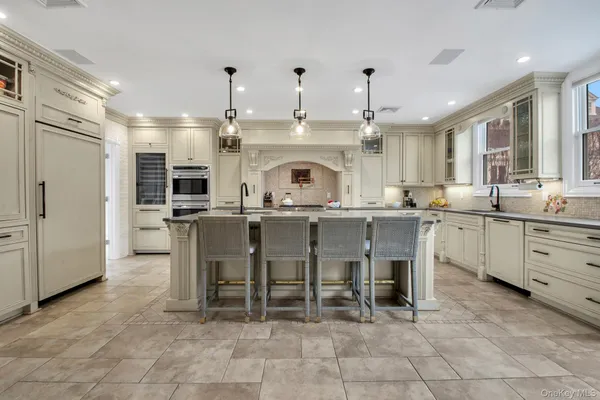 a kitchen with cabinets and chairs