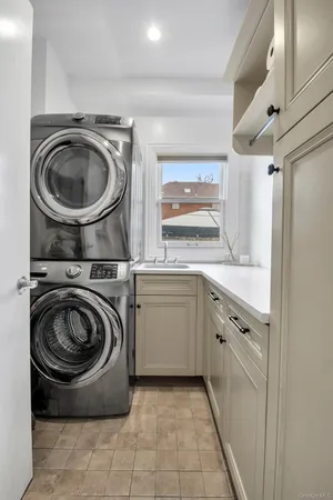 a utility room with sink washer and dryer