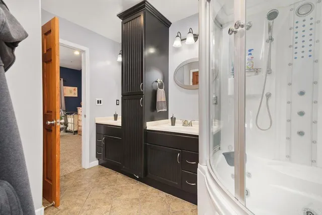 a bathroom with a granite countertop toilet sink and mirror