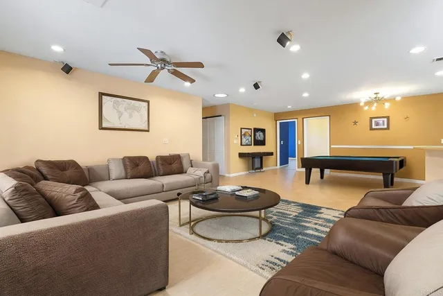 a living room with furniture and kitchen view