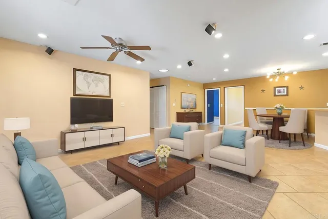 a kitchen with stainless steel appliances granite countertop wooden cabinets a dining table and chairs