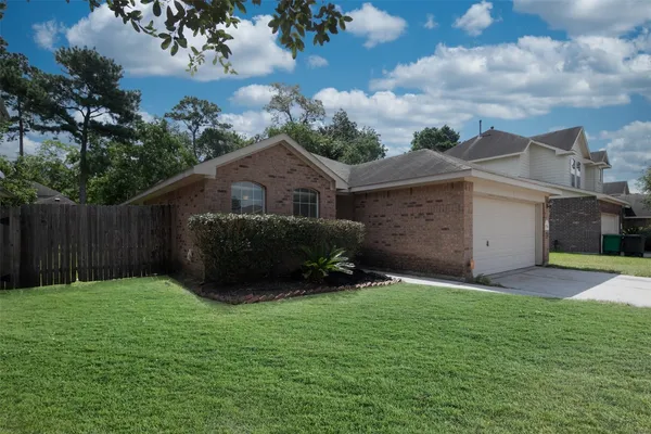 a view of a backyard with a garden and entertaining space