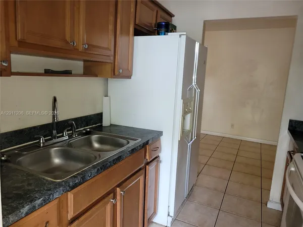 a kitchen with a sink and a refrigerator