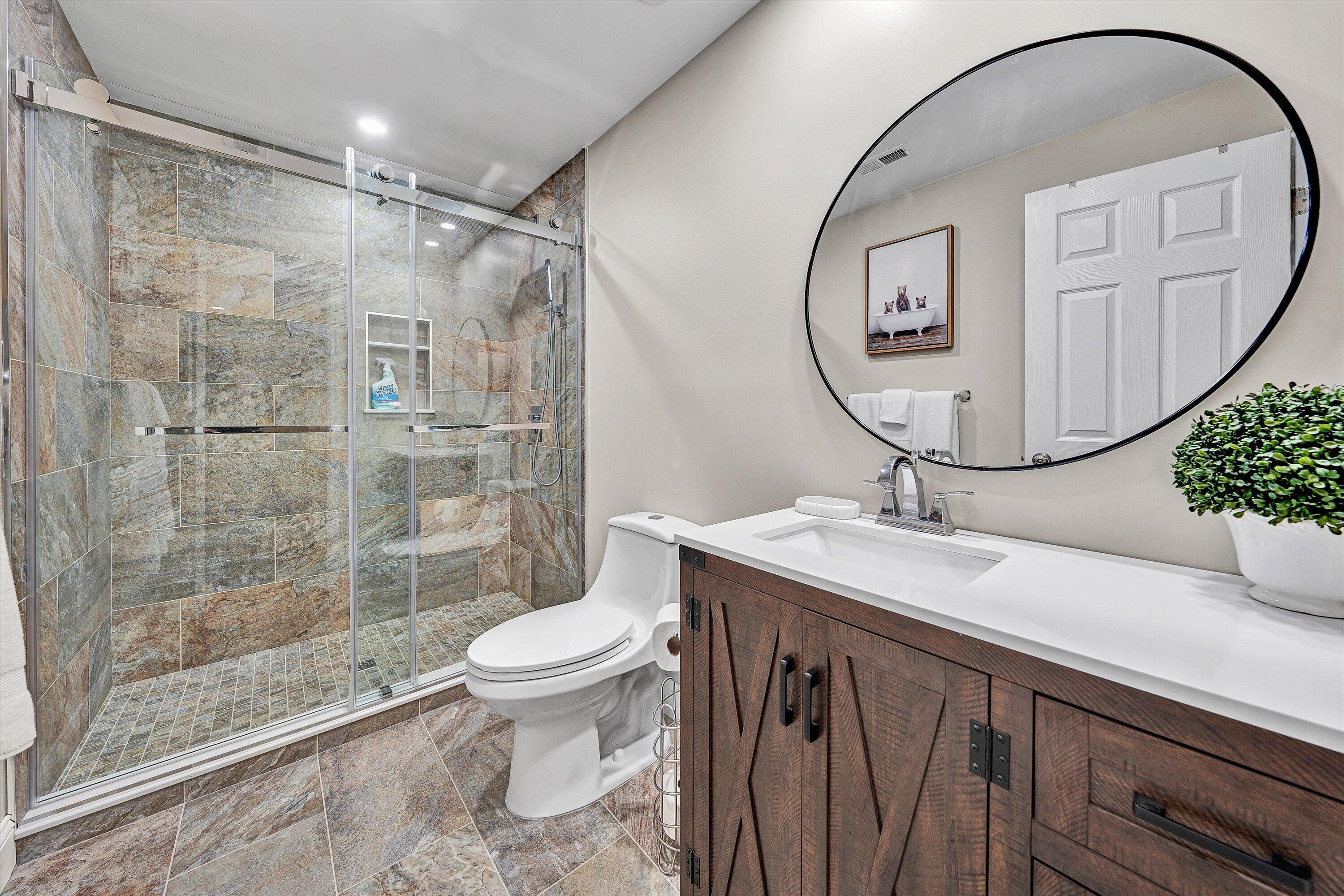 6211 Hillcrest Road Salem, VA 24153 - Photo 27 of 36 a bathroom with a granite countertop sink a toilet and a mirror