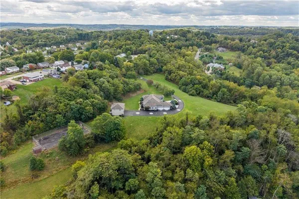 an aerial view of a house with a yard