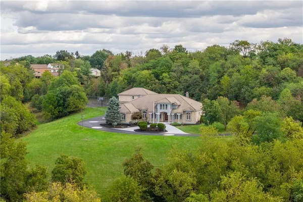 a view of a house with a yard and sitting area