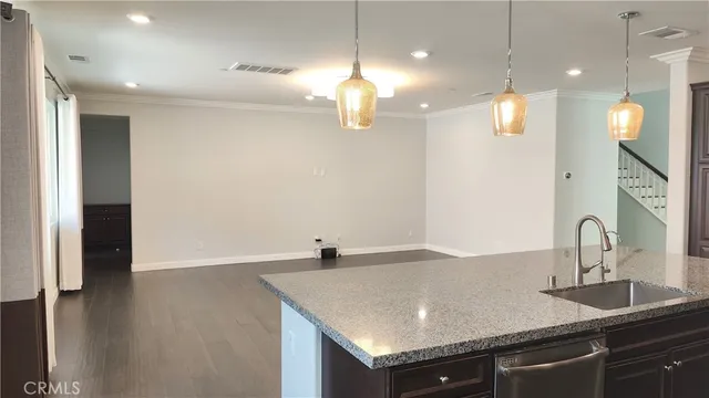 a kitchen with stainless steel appliances granite countertop a sink a oven and a refrigerator