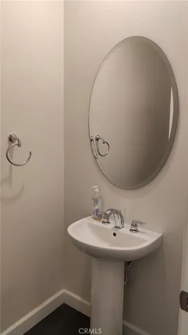 a bathroom with a granite countertop sink mirror vanity and toilet