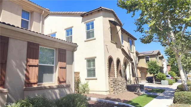 a view of an empty room with a window and fire place