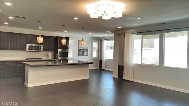 a view of a kitchen with a sink stainless steel appliances and cabinets