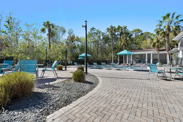 a view of a patio with couches table and chairs and potted plants