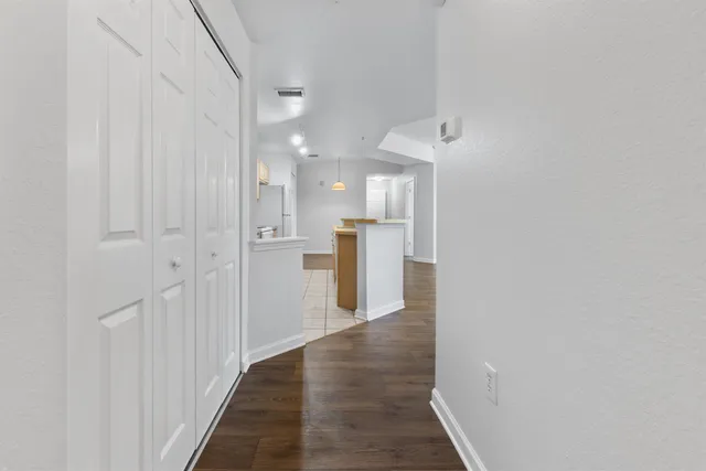 a view of a hallway with wooden floor