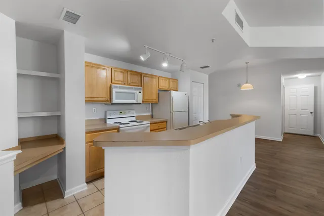a kitchen with kitchen island a sink appliances and cabinets