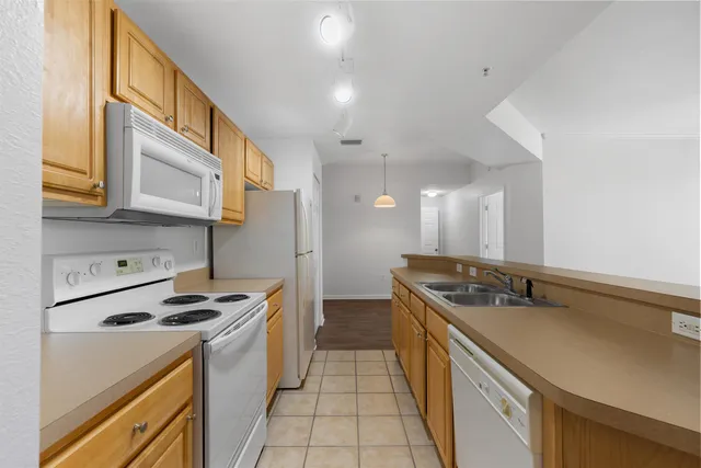a kitchen that has a sink and a stove