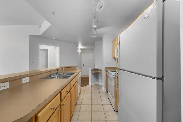 a kitchen with a sink and refrigerator