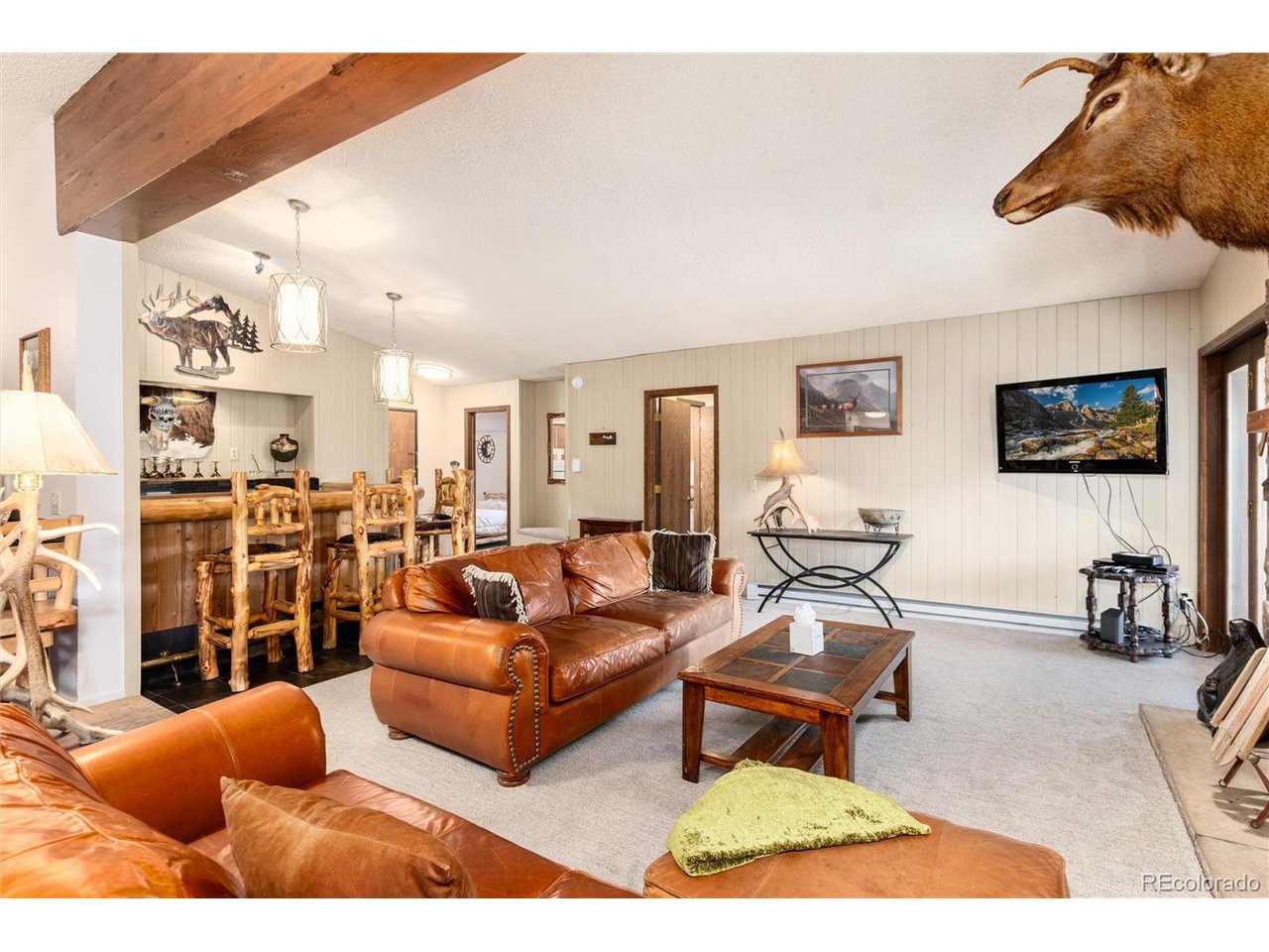 490 Kings Crossing Road, Unit 631 Winter Park, CO 80482 - Photo 6 of 43 a living room with furniture a rug and a flat screen tv